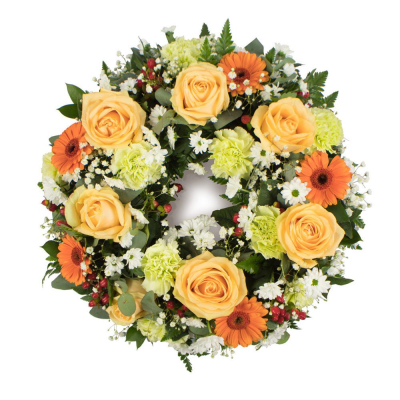 Wreath SYM-315 - A beautiful classic wreath arranged using peach and green flowers and finished with fine foliage.