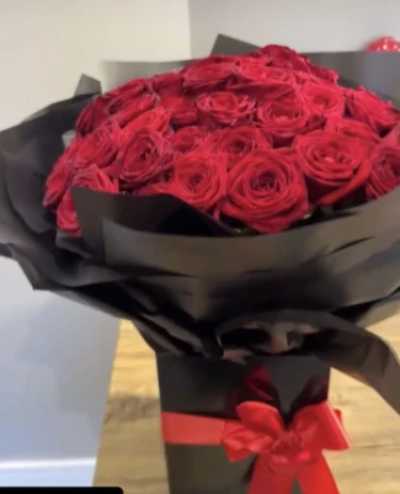 50 mega luxury roses - Pure luxury and romance. 50 Best red roses arranged in a modern style with dramatic wrapping in a water bubble box